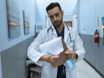 a healthcare professional in a hospital carrying important documents