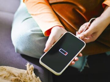 When to Repair or Replace Your Smartphone Battery a man holding a smartphone with battery issues